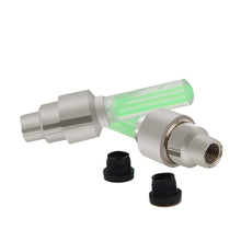 Metallic nozzle with green filter and black caps on a white background